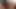 An adorable African-American woman with lovely hair enjoys a passionate sexual experience that involves her being pleasured by a black male companion while seated on their sofa.