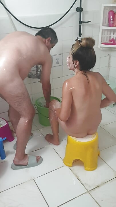 Old man bathing with his young girlfriend, Turkish couple in their natural home life.