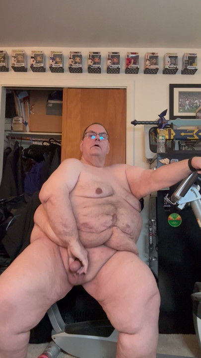 Old fat man masterbating on exercise bike