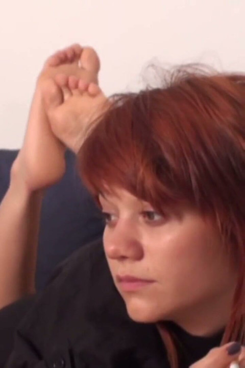 Redhead teen enjoys smoking a cigarette