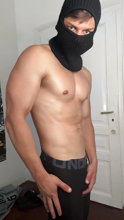 Masked hunk showing off his muscles