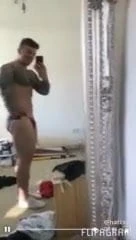 Tattooed model showing off in mirror