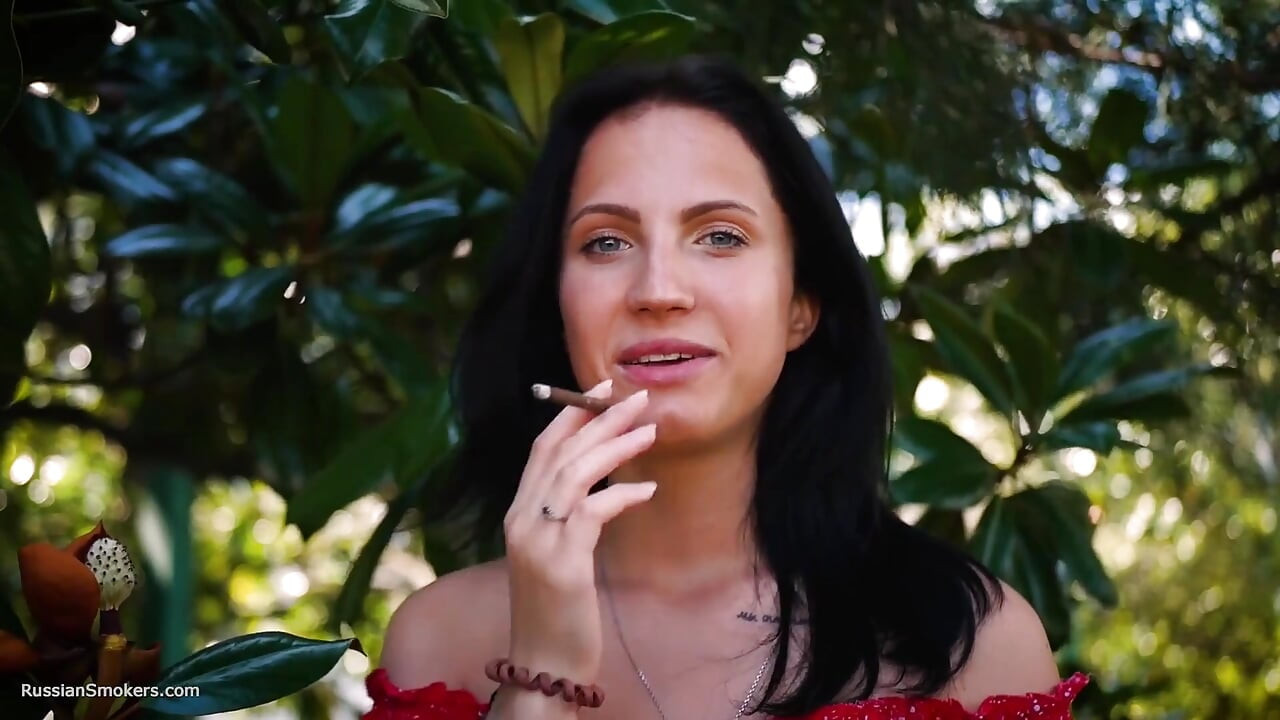 Sultry Brunette in Red Dress Smoking Rolled Cigarette