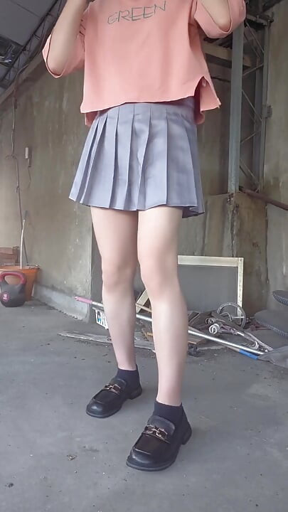 A Pleated Skirt Paired with White Underwear, and an Anal Plug Inserted on the Terrace