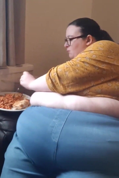 SSBBW huge belly whilst eating on sofa