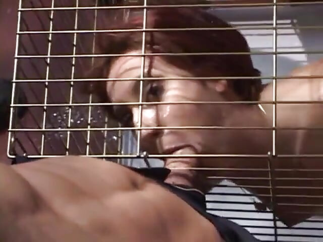Submissive slut blowing police officers dick while in cage