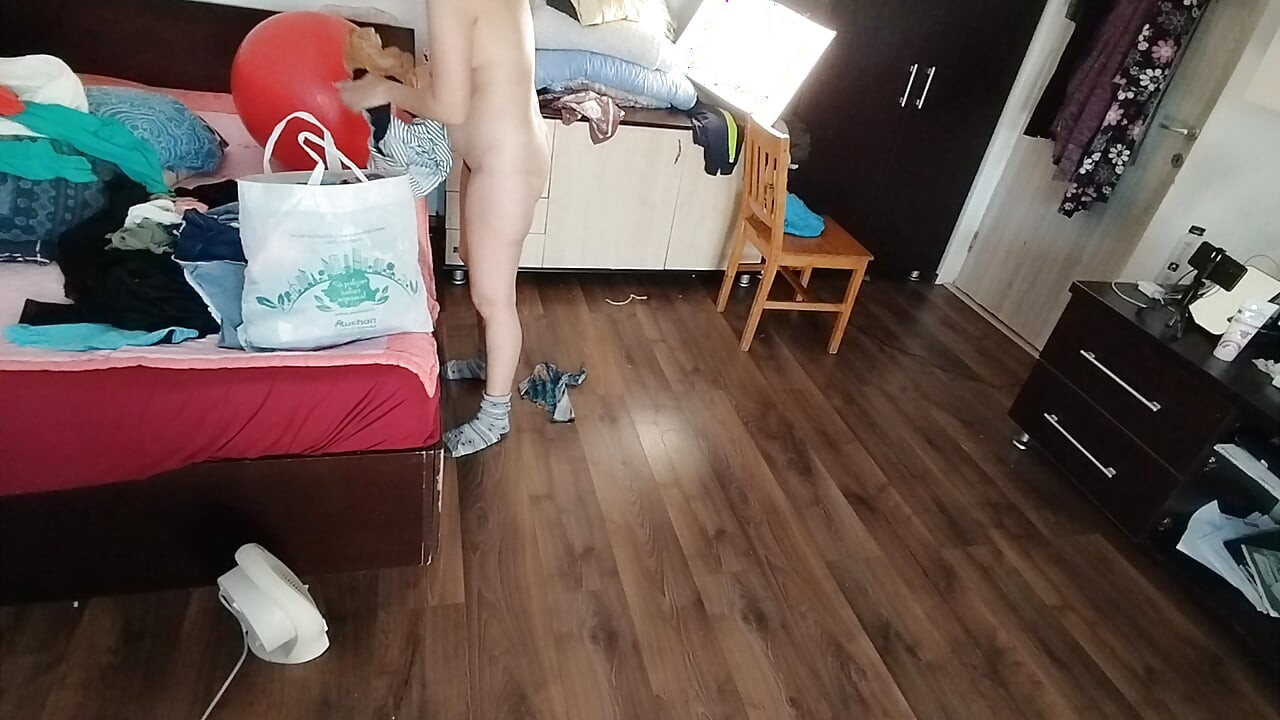 Sexy brunette doing naked chores around the house.