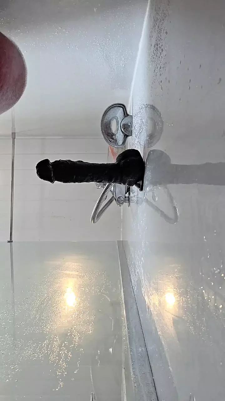 Un grande dildo nero in doccia