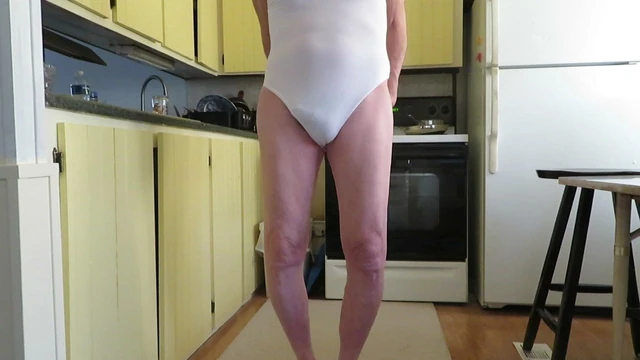 Sissy slut shows his fem ass cheeks in a woman's leotard.