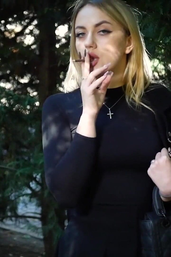 Hot Blonde Babe Smoking Two Black Cigarettes in Nature