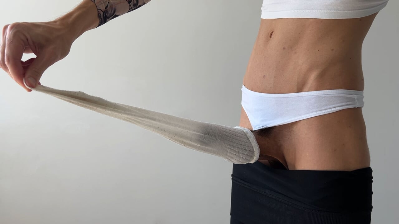 A femboy masturbates a big dick in a white sock and cums hands-free