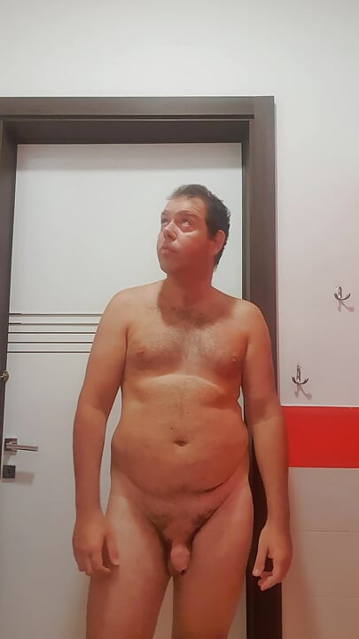 A boy completely naked in a station bathroom