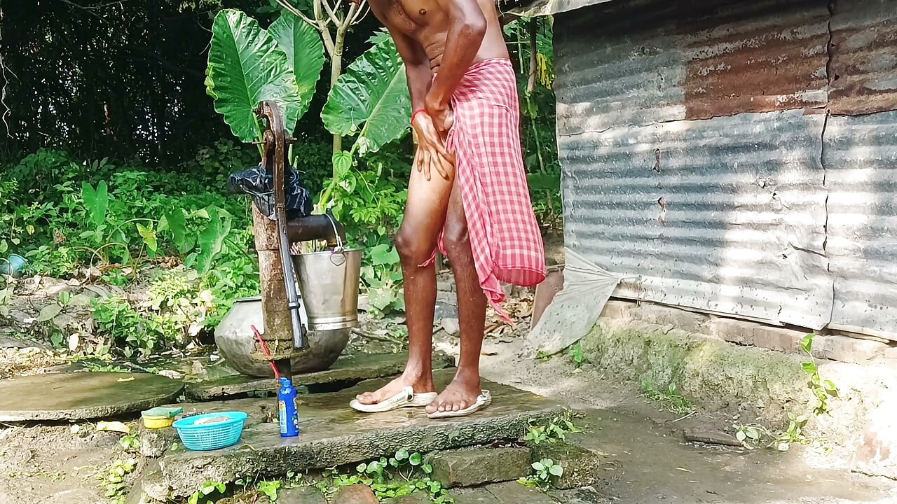 Desi young man bath Open place.