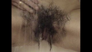 Very hairy Inge enjoys a shower after sport
