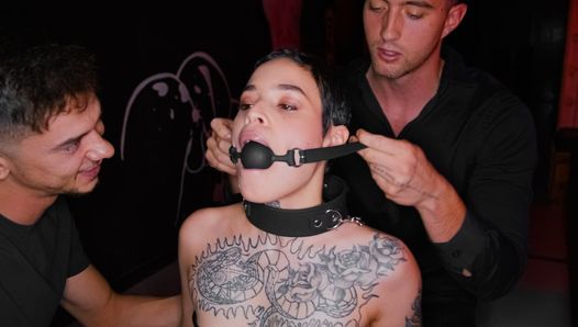 Obedient tattooed slut gets gagged and dominated by two rough guys in BDSM style