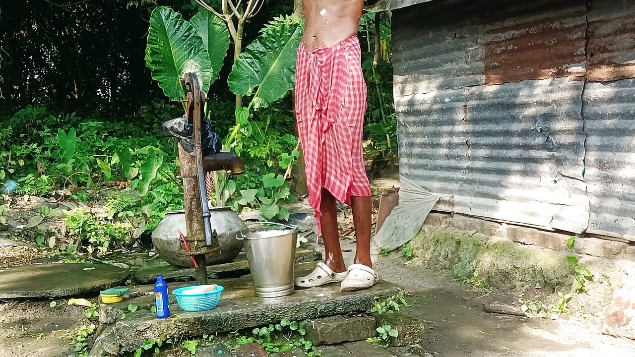 Desi young man bath Open place.