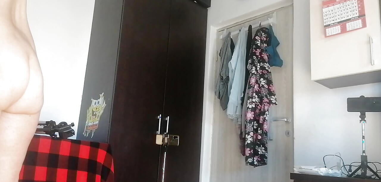 Amateur woman has fun trying on clothes and cutting them. Amateur woman vacuums naked in the house.