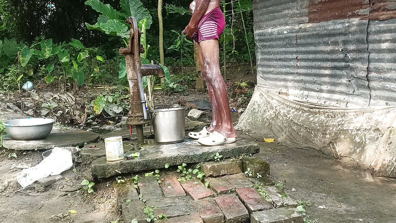 Black mature man bath in desi style. Showing big dick.
