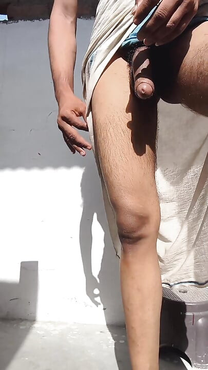 Young guy rubs his thick penis with oil