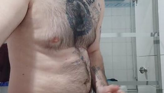 Il ragazzo peloso si spoglia nudo davanti allo specchio e si masturba