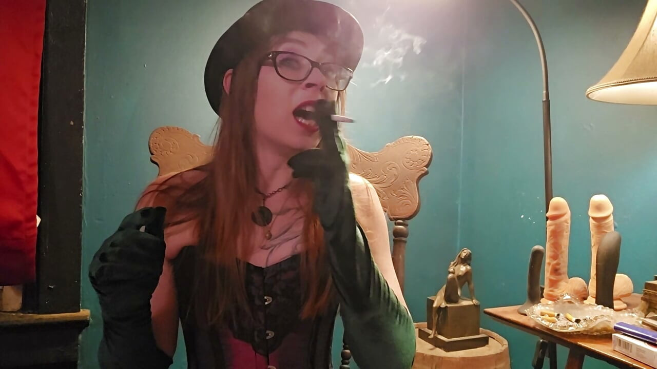 Smoking while wearing a purple corset, gloves, and a hat