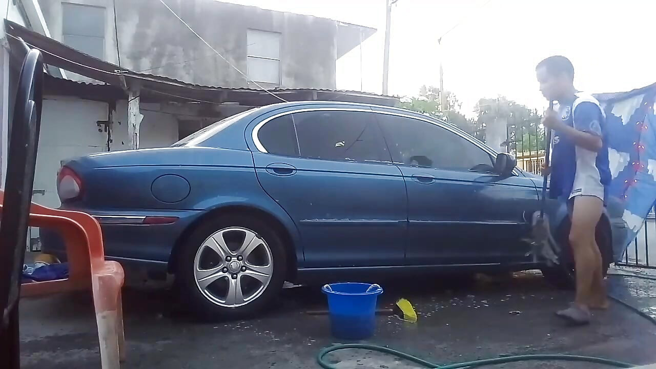 Jesus in gray boxer washing his jaguar car