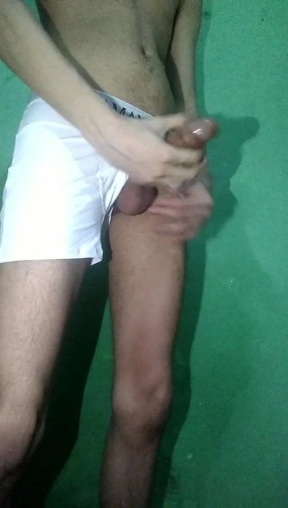 Skinny young boy taking off his white underwear