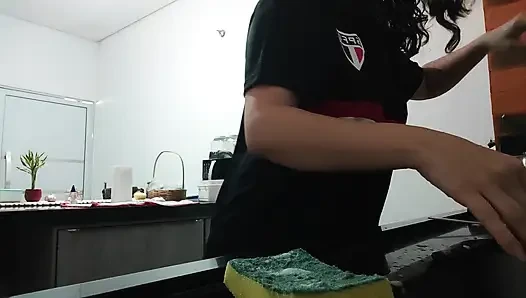 Woman teasing while washing dishes. She loves to transmit to the voyeurs on duty