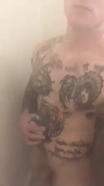 Tattooed muscle soldier in the shower