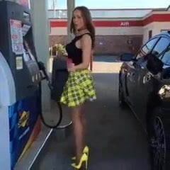 Classy girl pumping gas in yellow mini skirt