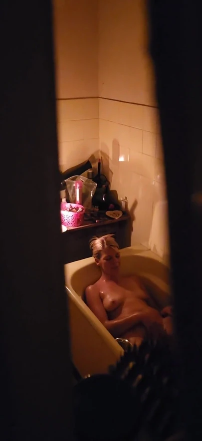 Captivating moment from "Peeping through my neighbours bathroom window,watch how she plays with her pussy"