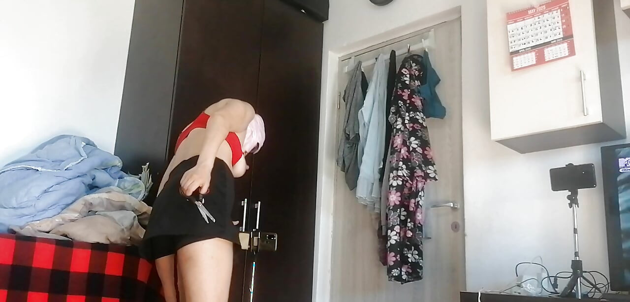 Amateur woman has fun trying on clothes and cutting them.