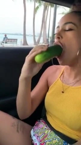 A women eating a cucumber
