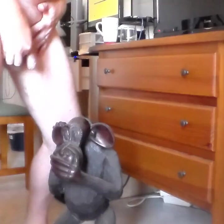 John is peeing on an ape statue
