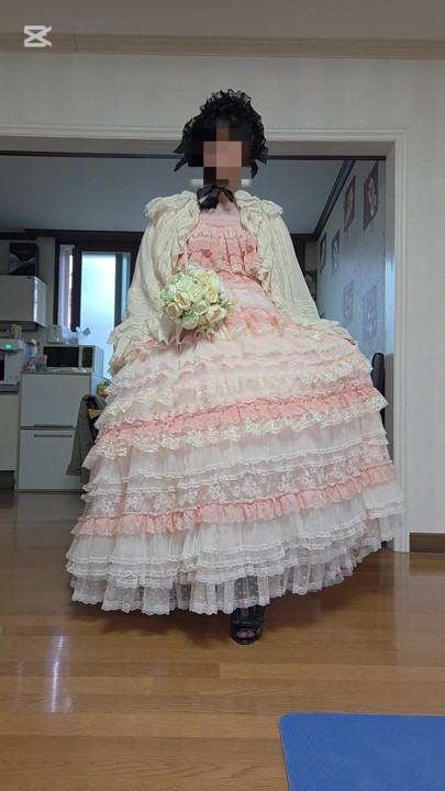 A man dressed as a woman dances in a dress.