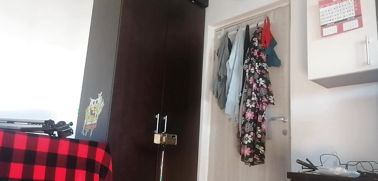 Amateur woman has fun trying on clothes and cutting them. Amateur woman vacuums naked in the house.