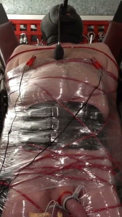 Frankenslave is suspended in cling film bondage with electro play in the dungeon of Lady Diva Cane | Clip 1