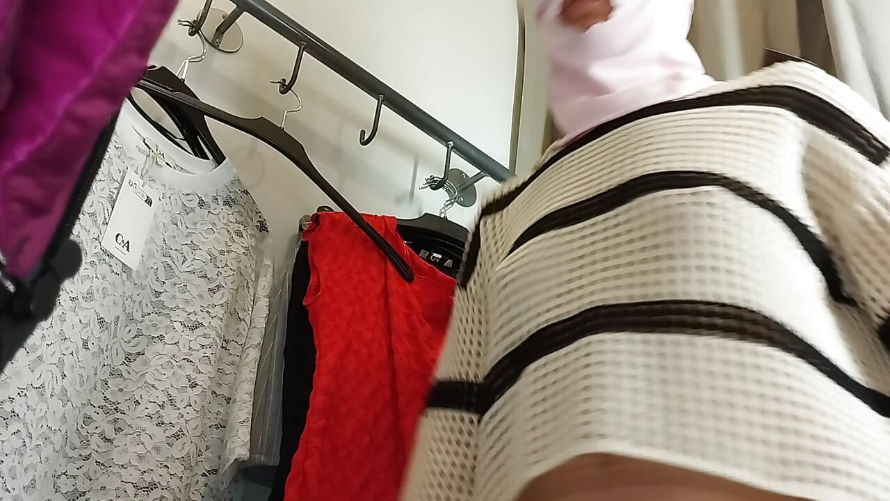 Sexy woman trying on clothes naked in the fitting room.