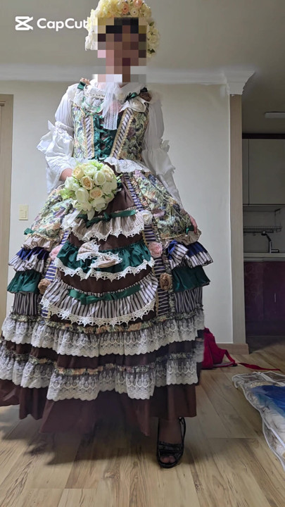 A crossdressing man is wearing a dress and dancing.