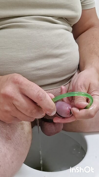 Cock stretching with 14mm ball sound and piss drained through silicone hose in peehole