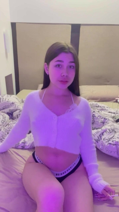 This busty lustful bitch sucks candy on the bed and dreams of a big dick