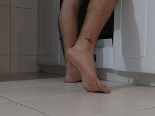 Latino shows his feet while cooking