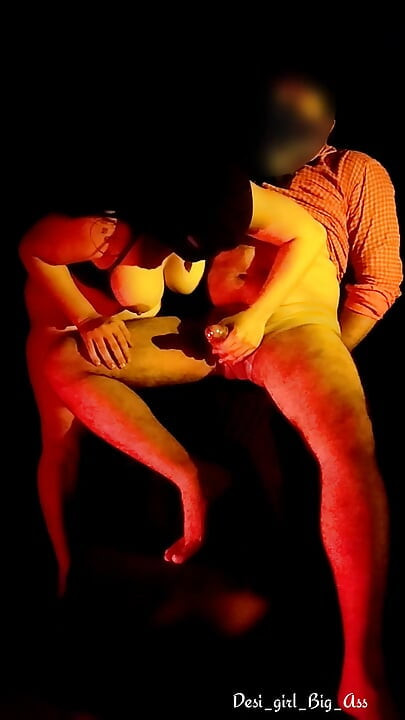 An Indian couple having intense sex in a dark room.