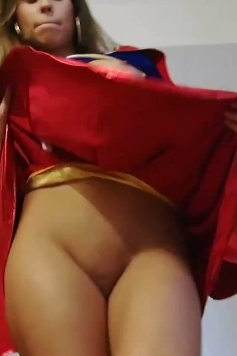 Beautiful babe in superman costume is dildoing her pussy