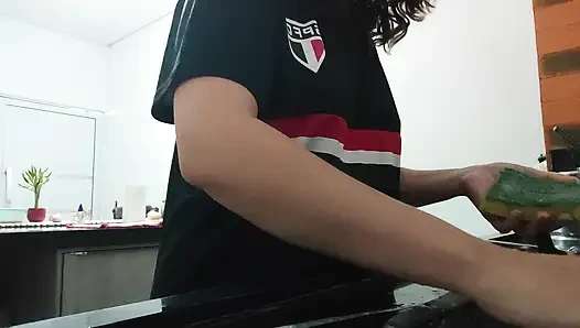 Woman teasing while washing dishes. She loves to transmit to the voyeurs on duty