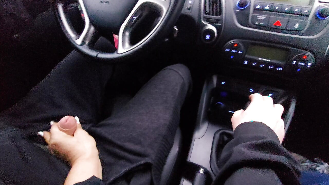 Amateur MILF gives a handjob to a taxi driver and teases him in the car, in public