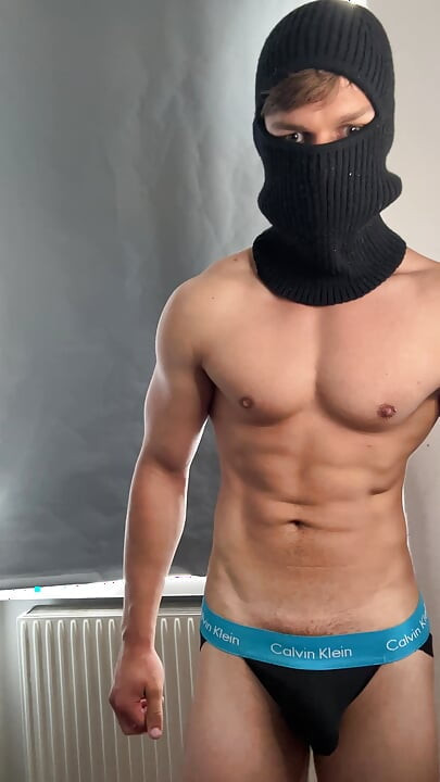 Young bodybuilder posing in a tight jock