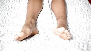 Luscious feet on a beautiful white sheet