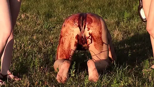sex slave bathes in chocolate in the field!
