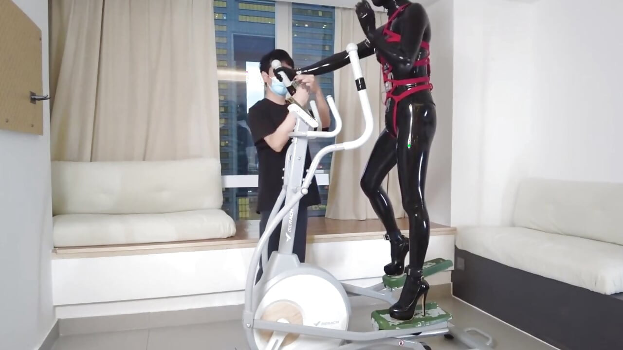 Mz27 - a Girl Bound in Latex Walks on a Treadmill